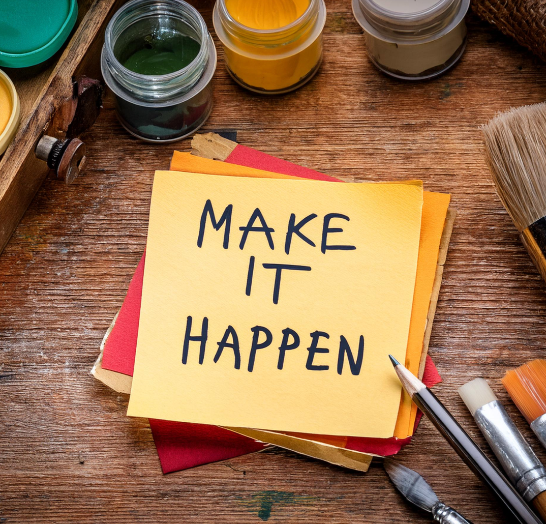 sticky note with make it happen written on